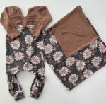 An adorable romper and a matching blanket for a sweet little girl.